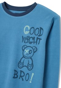 Sudadera de polar azul con cuello redondo, con "BUENAS NOCHES" y "¡BRO!" impresos en azul oscuro. Un gráfico de un oso de dibujos animados con una X en su ojo.