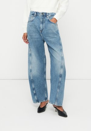 Light blue wide-leg jeans with a high waist, visible stitching, and two front pockets. The fabric appears slightly faded for a worn look.