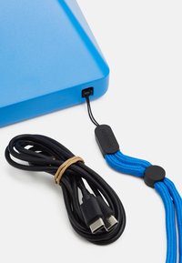 Blue rectangular device with a smooth finish, paired with a black USB cable and a blue braided strap featuring a black tag.