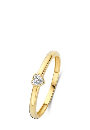 Gold ring with a polished finish, featuring a heart-shaped diamond accent mounted on one side. Sleek design and smooth surface.