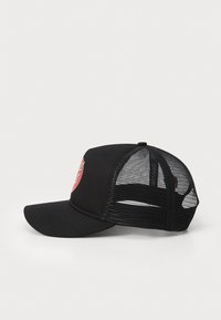 Black cap with a solid front and mesh back. Features a circular red logo design on the front. Curved brim and adjustable strap.