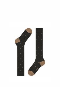 Schwarze Socken mit beigen Polka Dots, kontrastierenden beigen Zehen- und Fersenakzenten und dem Markennamen "FALKE" in Beige gedruckt.