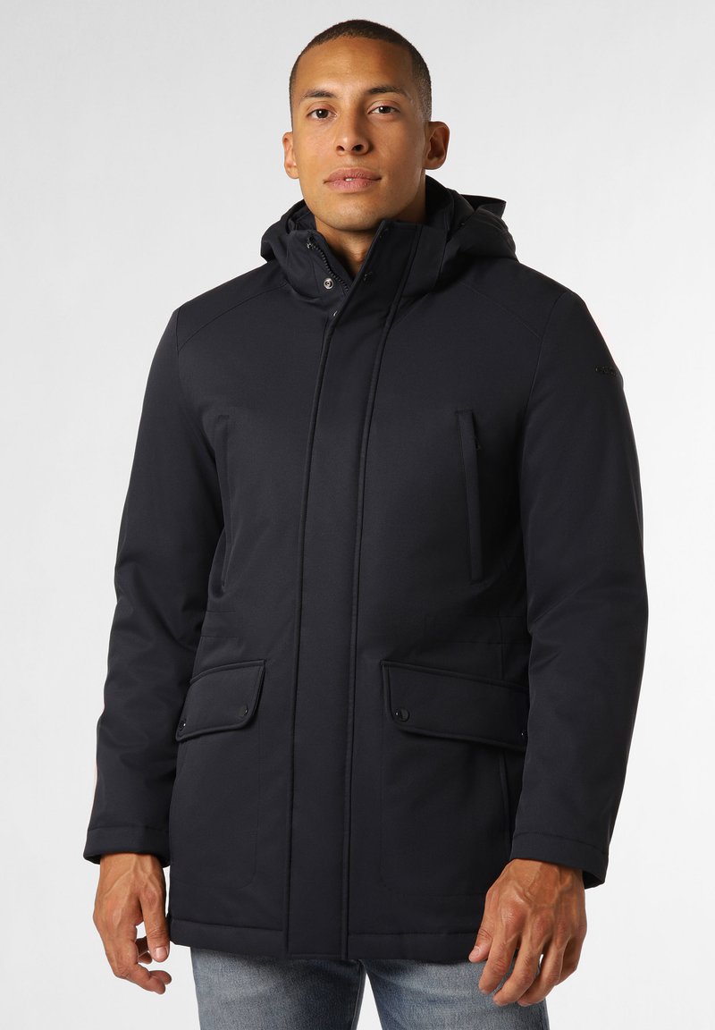 Veste extérieure noire imperméable avec capuche, dotée de fermetures éclair et de boutons-pression, de deux poches avant et d'une finition texturée.
