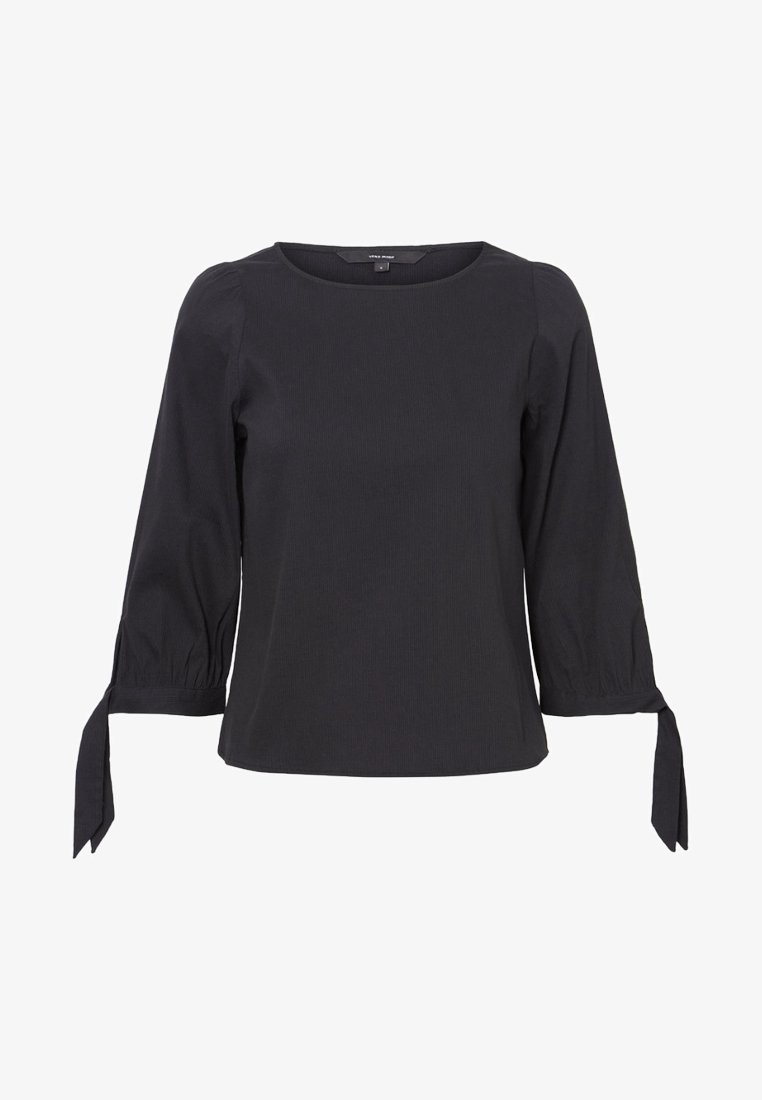 Blusa nera aderente con scollo rotondo, maniche a tre quarti a palloncino e dettagli con nodo ai polsini. Tessuto testurizzato con un motivo sottile.
