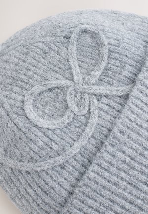 Gray knit beanie featuring a textured pattern and a decorative looped stitching detail on the top. Soft, cozy material.