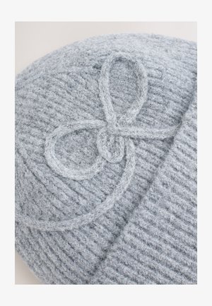 Gray knit beanie featuring a textured pattern and a decorative looped stitching detail on the top. Soft, cozy material.