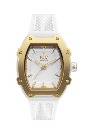 Montre avec bracelet en silicone blanc au design texturé, lunette octogonale dorée, cadran blanc et index et aiguilles dorés.