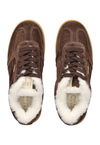 Brown suede sneakers with white fur lining, brown laces, and rubber soles, shown from a top-down view.