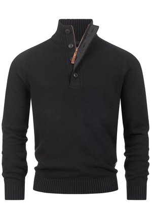 Svart stickad tröja med hög ribbad krage, tre knappar, framdragkedja, texturerad yta och ribbade ärmslut och nederkant.