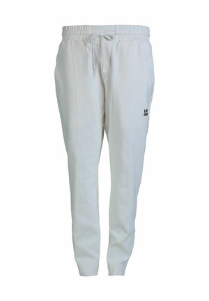White jogger pants made of soft fabric, featuring an elastic waistband with drawstring, and a small black logo on the side.