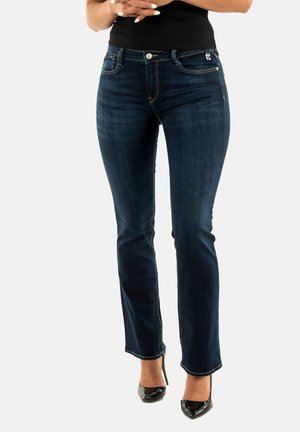 Jeans blu scuro in denim, con vestibilità slim, cuciture sottili, design tradizionale a cinque tasche e chiusura con bottone.