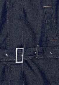 Dark blue denim fabric featuring a wide belt with a rectangular silver buckle, yellow stitching, and a side patch pocket detail.