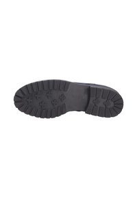 Suola di scarpa in gomma nera con un motivo testurizzato a strisce e prese a forma di stella. Il logo centrale presenta il nome del marchio "Gabor."