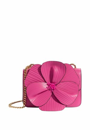 Pink handbag with a large 3D flower design on the front, featuring ribbed petals and a gold chain strap. Smooth leather texture.