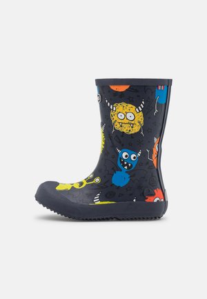 Rubber rain boot in navy, featuring colorful monster illustrations. Round toe, textured sole, and a smooth finish with a contrasting navy top.