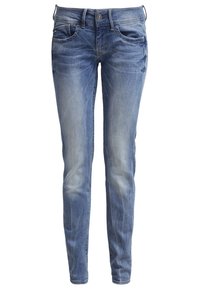 Jeans ajustados azul desgastados con cinco bolsillos, cierre de botón y ligero desgaste. La tela parece suave con una textura lisa.