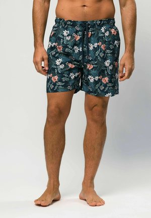 Férfi úszónadrág sötét türkizkék színben, trópusi, rózsaszín és fehér virágmintával. Rugalmas derékpánttal, húzózsinórral és bő szabással rendelkezik.
