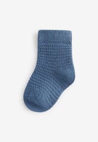 Blå stickad strumpa med ett texturerat mönster, med ribbad mudg och förstärkt häl samt sömlös tå för komfort.