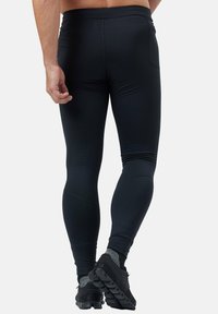Zwarte sportlegging in een aansluitend design, gemaakt van rekbare stof met een gladde textuur, met een hoge tailleband en tot aan de enkels.