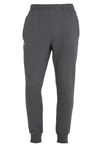 Grå sweatpants i bomullsblandning, med elastisk midjeband och muddar vid anklarna. Diskret logotypdetalj på sidan.