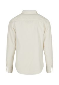 Cream long-sleeve shirt, button-down style, made from a textured fabric, featuring a classic collar and buttoned cuffs, solid color.