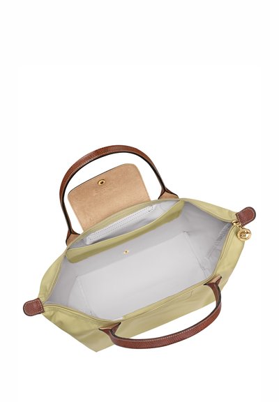 Green fabric tote bag with brown leather handles, showing a spacious light interior and a small pocket with a snap closure.