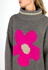 Gray knit sweater with a large pink flower design, featuring a chunky fold-over collar with a gold accent. Soft texture, relaxed fit.