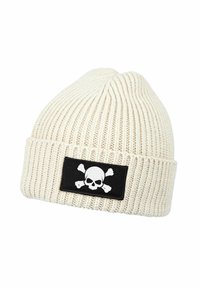 Cream rib-knit beanie with a black patch featuring a white skull and crossbones design. Soft texture and fitted shape.