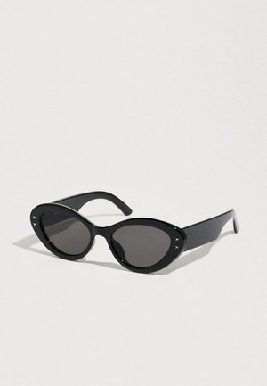 Black sunglasses with an oversized cat-eye shape. Smooth plastic frames with dark lenses and small star accents on the sides.