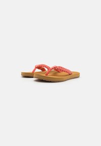 Coral braided flip-flop sandals with a tan footbed, featuring a textured sole for grip and a rounded, casual design.