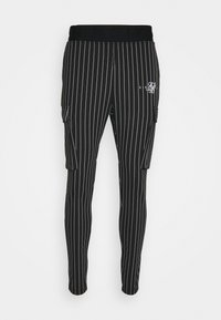 Svartrandiga joggingbyxor med en bekväm midja, med sidofickor och en liten vit logotyp på vänster lår.