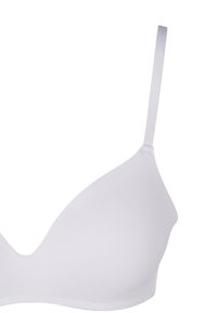 White, seamless bra with a soft finish, triangular cups, adjustable straps, and no visible hardware, designed for comfort and support.