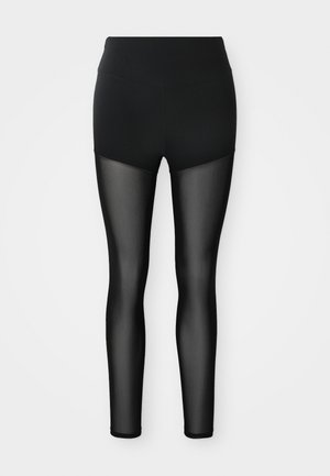 Svart leggings med solid høy midje og gjennomsiktige mesh-paneler som dekker bena fra midt-lår til anklene.