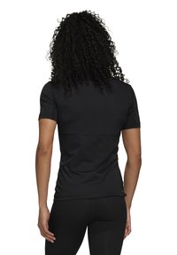 Black athletic jersey with short sleeves, smooth texture, fitted design, and seam detailing along the back and sides.