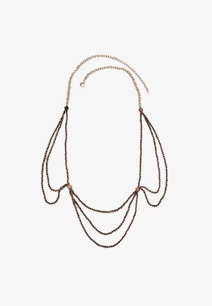 Delikatny naszyjnik ze złotym łańcuszkiem i kilkoma drapowanymi nitkami małych ciemnych koralików, połączonymi okrągłymi złotymi zapięciami.