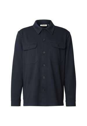 Tumesinised triiksärk pikemate varrukatega, valmistatud pehmest kangast, millel on nööbitav eesmine osa, krae ja kaks rinnataskut nööpkinnitustega.