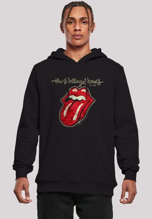 Black hooded sweatshirt featuring a distressed red tongue logo with white accents, gold text reading "the Rolling Stones EST 1962" above it.