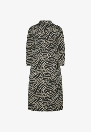 Musta-valkoinen kuvioitu polvipituinen mekko, jossa on pitkät hihat, kaulus ja kolme nappia edessä.
