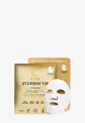 Sachet de masque visage revitalisant en biocellulose Gold Starskin VIP à côté d’un masque en tissu blanc.