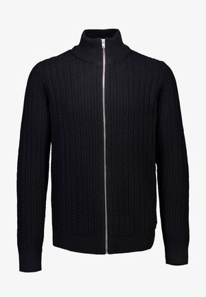 Felpa nera con zip realizzata in maglia, caratterizzata da una texture a costine, collare alto e motivo a zig-zag. Anche i polsini e l'orlo sono a costine.