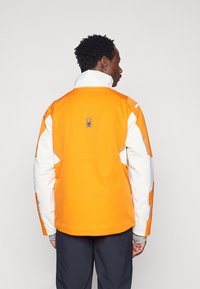Spyder TITAN JACKET - Jachetă schi - orange shock