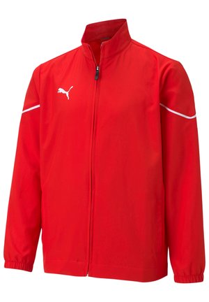 Veste rouge en tissu léger avec un col droit, fermeture éclair à l'avant, poignets élastiques et coutures blanches en accent. Logo Puma sur la poitrine.