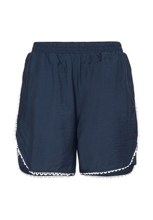 Laivastonsiniset naisten shortsit, joissa on joustava vyötärönauha ja valkoiset, aaltoilevat pitsikoristeet helman ja sivujen kohdalla.