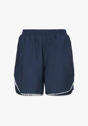 Laivastonsiniset naisten shortsit, joissa on joustava vyötärönauha ja valkoiset, aaltoilevat pitsikoristeet helman ja sivujen kohdalla.