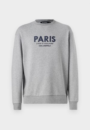 Siv sweatshirt z okroglim izrezom, ki ima vezeno temo "PARIZ" in podrobnosti naslova v mornarsko modri barvi. Mehka tkanina z rebrastimi manšetami in robom.