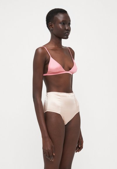 Bralette triangular de satén rosa con tirantes finos, combinado con braguitas de satén color marfil claro de tiro alto. Textura suave, diseño estructurado.