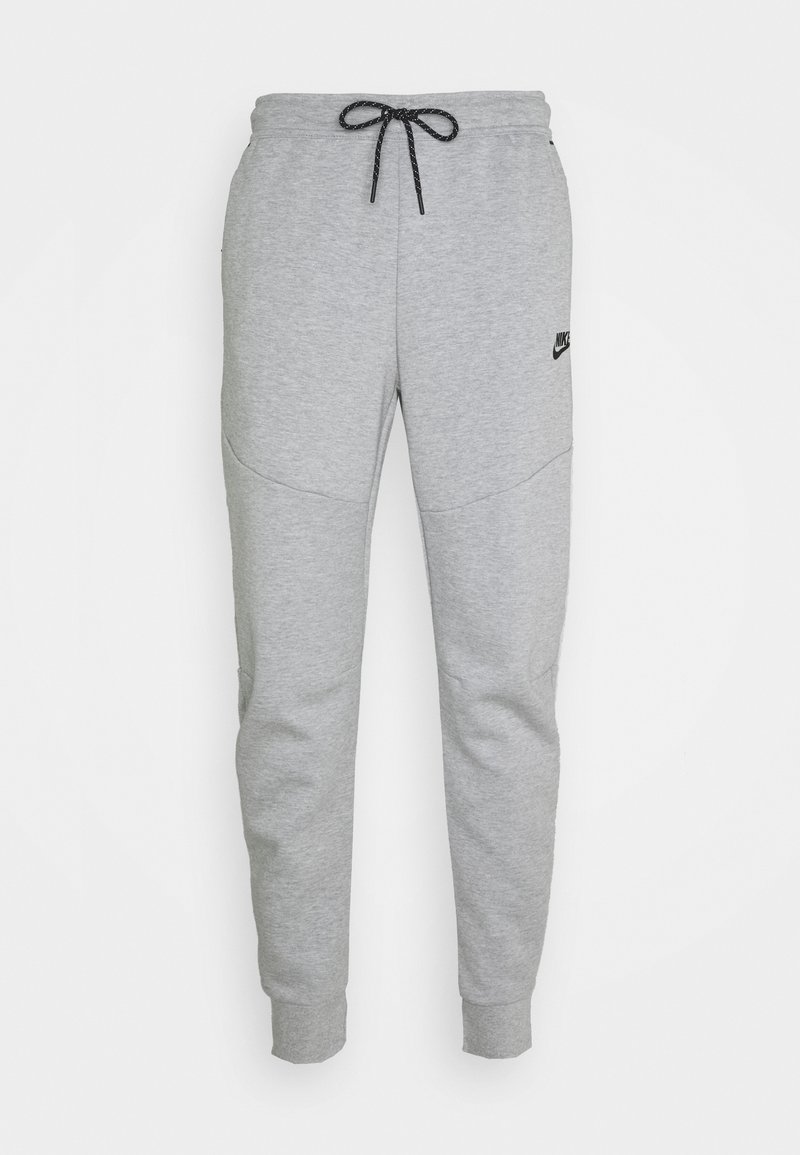 Pantalones de chándal grises hechos de una tela suave, con una cinturilla elástica con cordón, piernas ajustadas y un pequeño logo en el muslo.