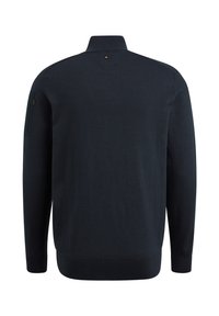 Dark navy knitted pullover with a high collar, long sleeves, side pocket, and ribbed hem. Smooth texture with minimal hardware detail.