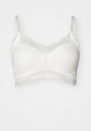 White lace bralette with a textured underlayer, scalloped edges, and adjustable thin straps. Smooth cups with decorative lace details.