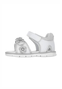 Sandalo bianco con decorazioni floreali, cinturino in Velcro, lati in rete e una suola imbottita. Presenta accenti argentati sui fiori.